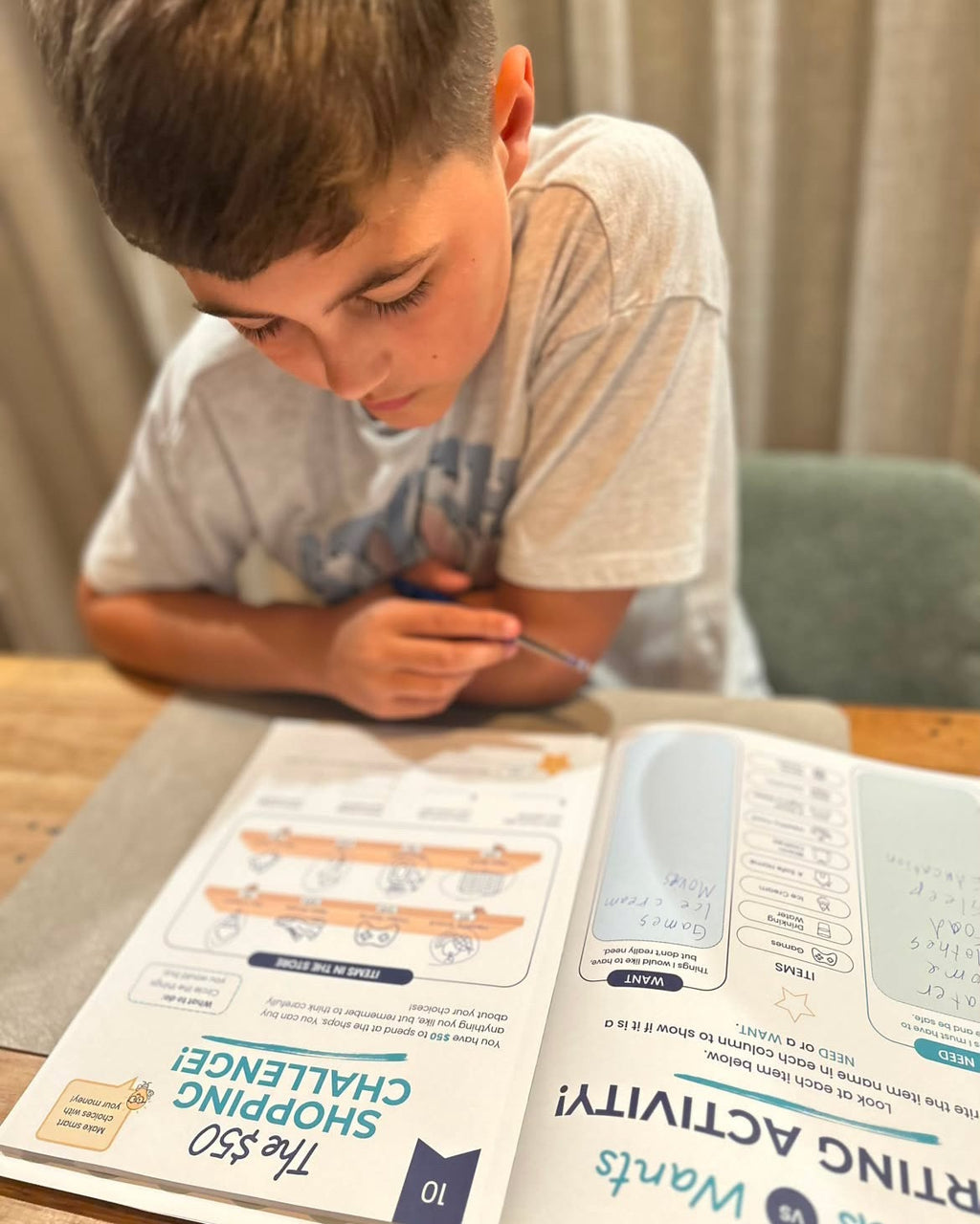 Child completing the $50 Shopping Challenge in My First Money Journal.